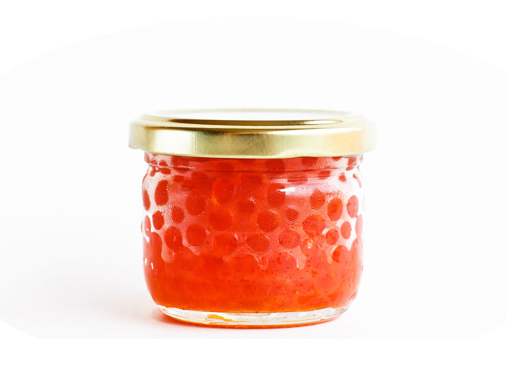 Ikura Caviar in a glass 2 oz. jar with a gold lid.